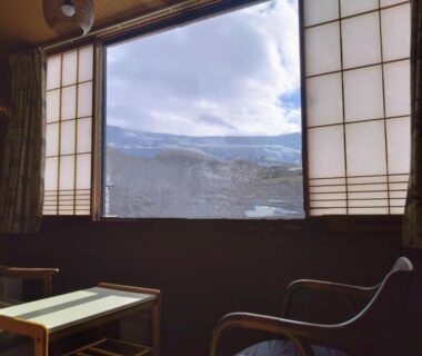 Low seating and shoji screens framing mountain view at Ringoya in Zaō Onsen, Yamagata