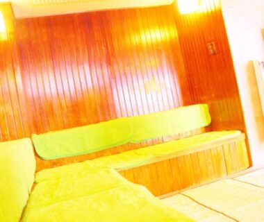 Wood-paneled interior with green bench cushions and tatami flooring at Kashikojima Park Hotel Michishio Mie