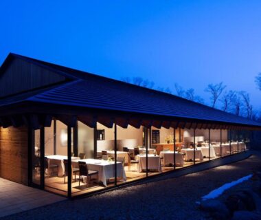 Evening interior with floor-to-ceiling windows and tables at Nasu Muku no Ne in Tochigi Kantō Japan