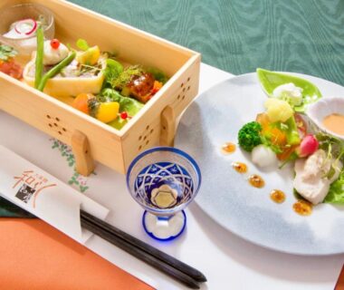Wooden bento box and plated appetizers, ceramic cup and chopsticks at Sato no Yu Waraku, Kumamoto