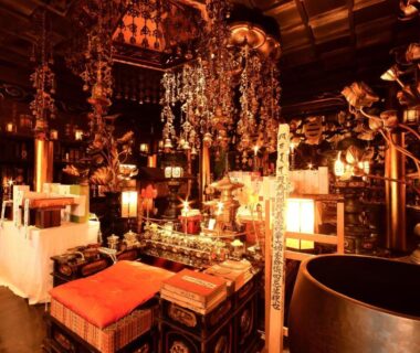 Interior shrine room with hanging ornaments, ritual bells, lacquered altar and cushions at Kongo Sanmaiin Wakayama