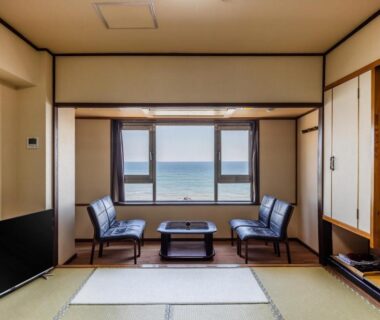 Tatami mat room with low table and chairs facing a coastal window at Choshi Grand Hotel, Chiba