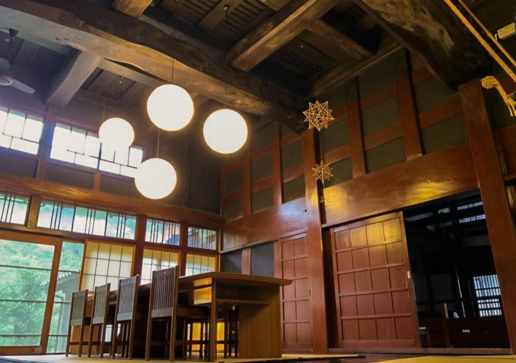 Traditional wooden dining hall Zenigame Chūbu Ishikawa Japan High wooden ceiling dining room with shoji and round pendant lights, Zenigame, Chūbu, Ishikawa, Japan