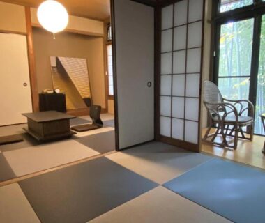 Tatami room with shoji screens and veranda seating overlooking bamboo at Abekura Onsen, Kanagawa
