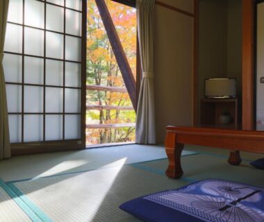 Tatami room with low wooden table and shoji, garden view at Suzumenoyado Yagura in Nagano