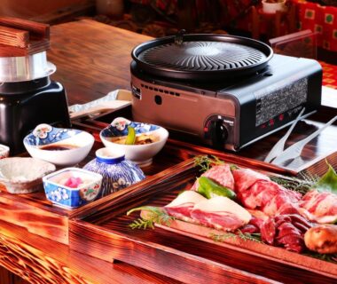 Tabletop grill with raw meats and side dishes at Gesseitei auberge de la mer de nuages Hyōgo