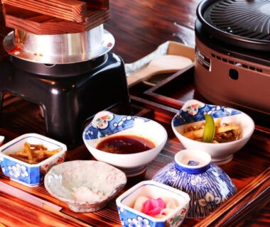 Assorted Japanese side dishes and rice on lacquered tray with tabletop grill at Gesseitei, Hyōgo