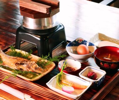 Japanese breakfast tray with grilled fish, pickles, miso soup and small side dishes
