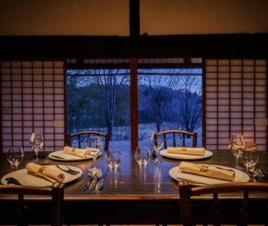 Tatami dining table set by shoji doors overlooking snowy mountains at Kaze no Sawa, Miyagi