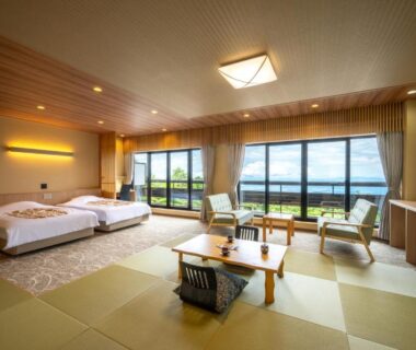 Spacious tatami room with Western beds, low table, large windows overlooking landscape at Kagetsu Highland Hotel Takayu Onsen Fukushima