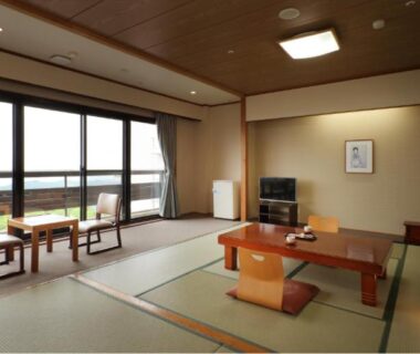Spacious tatami room with low table and balcony seating at Kagetsu Highland Hotel, Takayu Onsen, Fukushima
