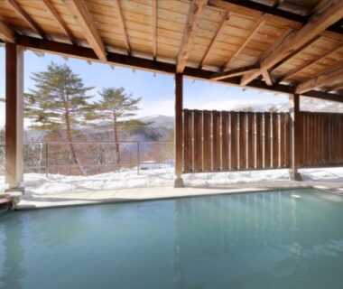Covered outdoor onsen bath with wooden roof and mountain view at Kagetsu Highland Hotel, Takayu Onsen, Fukushima