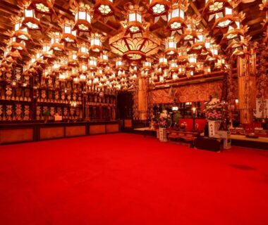 Ornate lanterns and red carpeted temple hall at Sanboin Koyasan in Wakayama, Japan