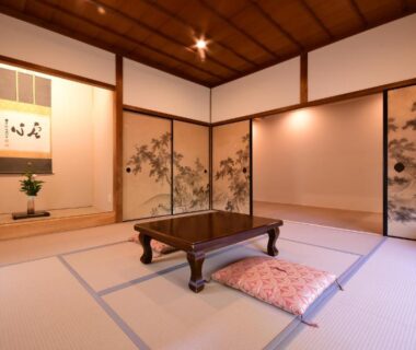 Traditional tatami room with low table, zabuton cushion, painted fusuma and tokonoma alcove at Koyasan Shukubo Sanboin Wakayama