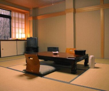 Traditional tatami room with low table, floor cushions, shoji screens and window at Koyasan Shukubo Fudoin Wakayama