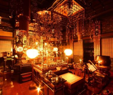 Buddhist altar with hanging lanterns, metal ornaments and shoji screens inside Komyoin shukubo Koyasan Wakayama