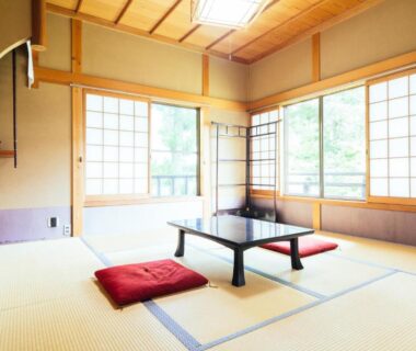 Tatami room with low table and red cushions at Koyasan Shukubo Zofukuin Wakayama overlooking greenery