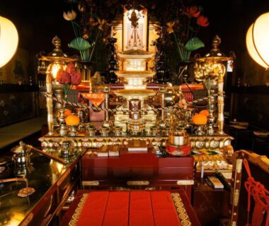 Golden Buddhist altar with lanterns, red cushions and offerings inside Koyasan shukubo Zofukuin in Wakayama