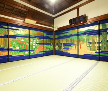 Spacious tatami room with painted fusuma panels and wooden ceiling at Koyasan Shukubo Daienin, Wakayama, Kansai