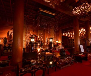 Buddhist altar with lanterns and wooden pillars at Koyasan Shukubo Daimyououin Wakayama