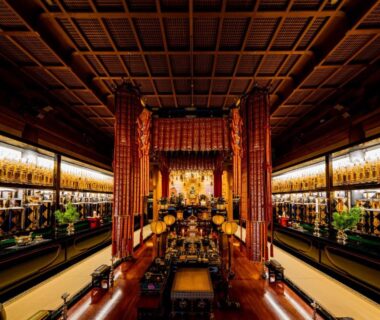 Buddhist temple interior with golden altar, hanging ornaments and polished wooden floor at Ekoin, Koyasan, Wakayama