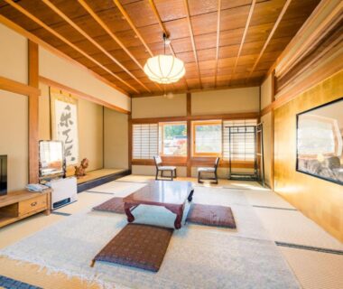 Spacious tatami room with low table, zabuton cushions, shoji screens and tokonoma alcove in Koyasan, Wakayama