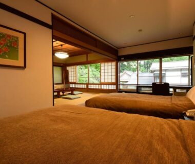 Twin beds in tatami room with shoji screens and garden view at Koyasan Shukubo Fumonin Wakayama