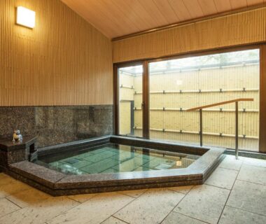 Stone indoor bath with glass doors and bamboo fence at Koyasan Shukubo Fumonin, Wakayama, Kansai Japan