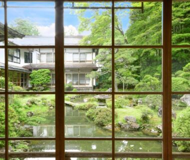 Shoji-framed view of a serene Japanese garden and pond at Koyasan Shukubo Fumonin in Wakayama