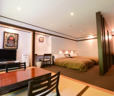 Room with tatami seating area, low table, chairs and Western bed at Koyasan Shukubo Fumonin, Wakayama