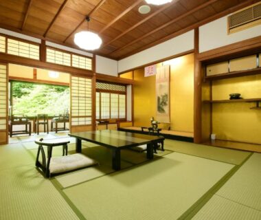 Traditional tatami room with low table, zabuton cushions, shoji screens and garden view at a Koyasan ryokan in Wakayama