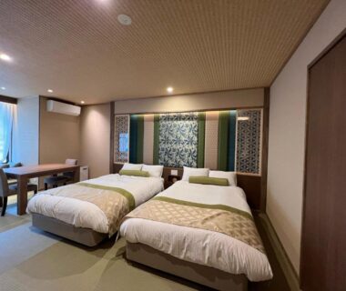 Tatami-style room with two beds, desk and shoji-style panels at Yurara Marukyō, Kinugawa, Tochigi