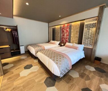 Contemporary twin bedroom with wooden accents and decorative panels at Yurara Marukyō, Kinugawa Onsen, Tochigi, Japan