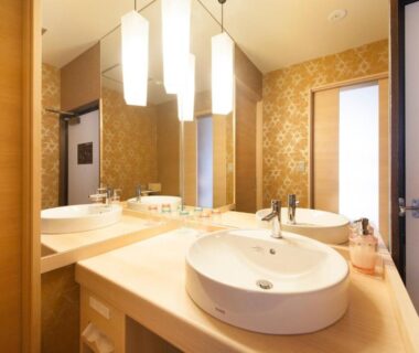 Ryokan bathroom vanity with round sink, mirrors and pendant lights at Yurara Marukyō, Kinugawa Onsen