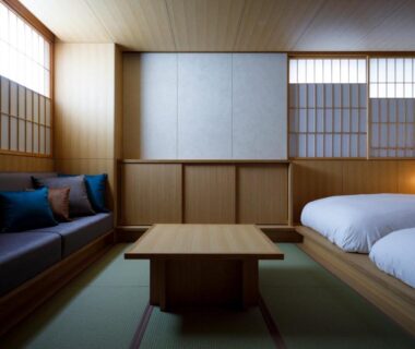 Tatami flooring, low table, sofa, shoji screens and twin beds at Kurumiya in Ishikawa, Chūbu Japan