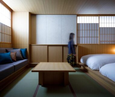 Tatami room with low table, sofa, shoji screens and twin beds at 黒梅屋 Kurumiya, Ishikawa