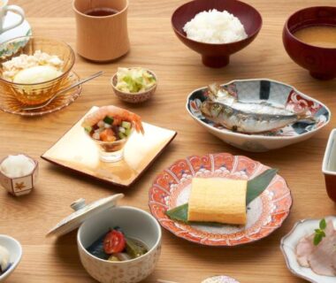Assorted Japanese breakfast dishes on table at Kurumiya, Chubu Ishikawa ryokan