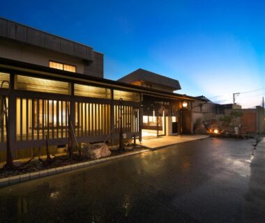 Entrance with wooden lattice and warm lights at Kuroshio no yado Rinkaisou in Chiba